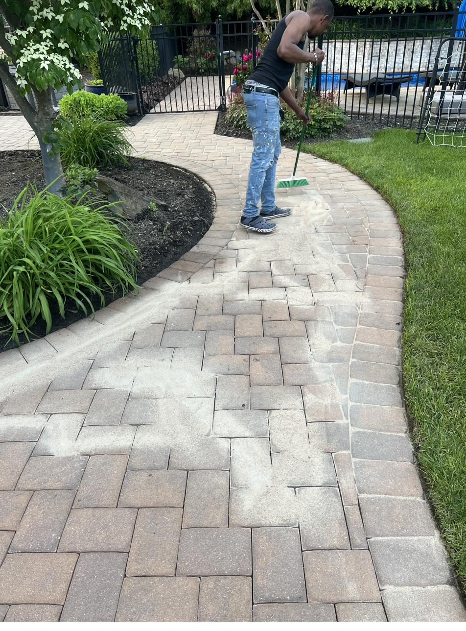 Crew installing curved paver walkway