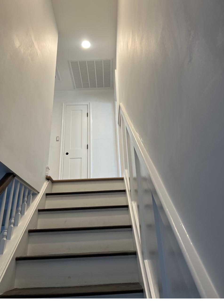 Staircase with freshly painted white trim